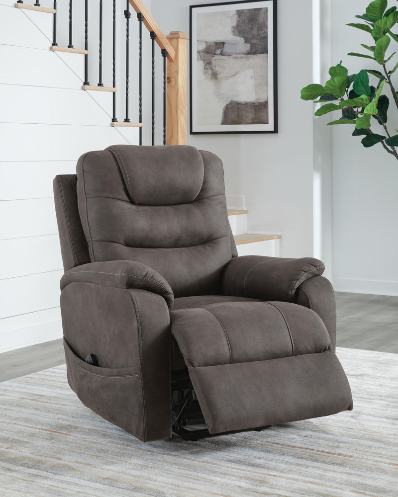 Signature Design by Ashley Snowfield Power Lift Recliner in gunmetal with padded armrests and plush cushioning.