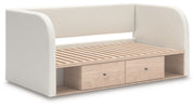 Upholstered day bed by Signature Design Ashley featuring plush fabric, wooden frame, and a modern, cozy design for versatile living spaces.