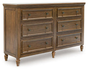 Benchcraft Sturlayne 6-piece panel bedroom set featuring a bed, dresser, mirror, and matching nightstands in a modern design.