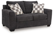 Benchcraft® Loreo stationary loveseat with plush cushions and modern design, perfect for cozy living room seating.