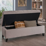 Noble House Juliana storage ottoman with birch wood legs, upholstered in neutral fabric, serving as a stylish and functional accent piece.
