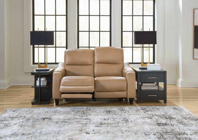 Ashley Mosswell power reclining loveseat with adjustable headrest in toffee, showing plush cushions and reclining mechanism.
