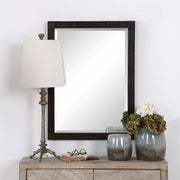 Aged black Gower vanity mirror by Uttermost with a sleek, rectangular frame and modern design for elegant bathroom or bedroom decor.
