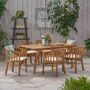 Noble House 7-piece outdoor dining set with cream cushions, includes six chairs and a matching table for outdoor dining.