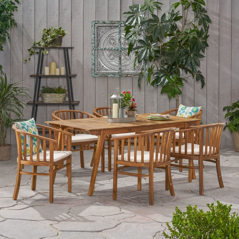 Noble House 7-piece outdoor dining set with cream cushions, includes six chairs and a matching table for outdoor dining.