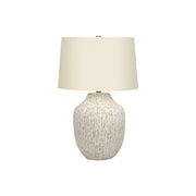 Cream ceramic transitional table lamp with a sleek design, featuring a rounded base and a fabric shade for elegant lighting.