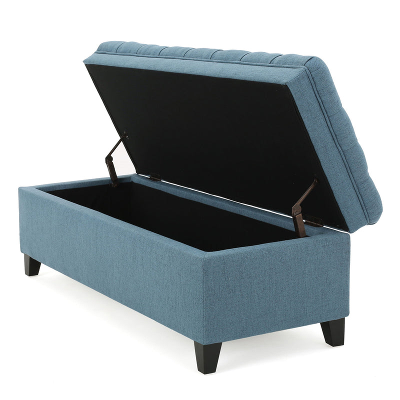 Noble House Juliana storage ottoman with birch wood legs, padded fabric top, and spacious interior for versatile home storage.