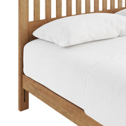 Ridgecrest Home Malinda panel bed with a wooden headboard and frame, shown in a modern bedroom setting.