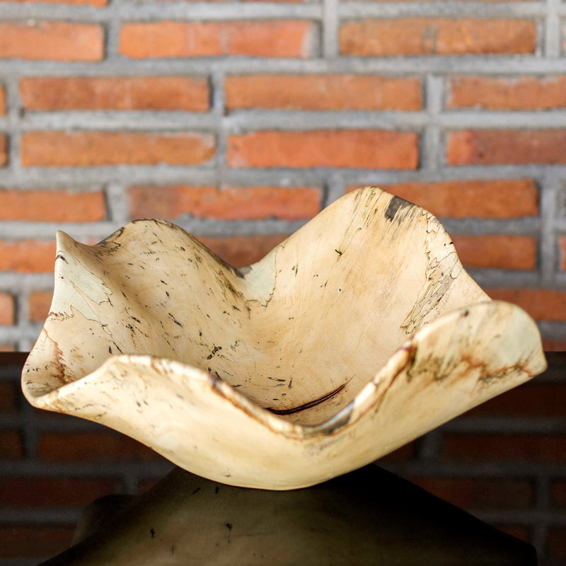 Light brown Tamarine wood bowl by Uttermost, round plate with smooth finish, ideal for serving or decorative display.
