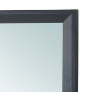 Glory Furniture Primo mirror with a sleek, modern frame, hanging on a wall in a contemporary living space.