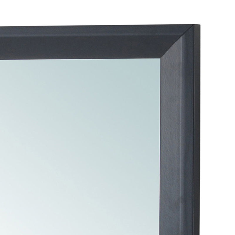 Glory Furniture Primo mirror with a sleek, modern frame, hanging on a wall in a contemporary living space.