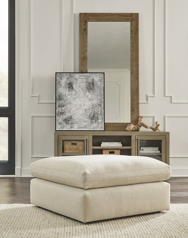 Benchcraft® Elyza oversized accent ottoman with plush fabric and modern design, shown as a versatile home decor piece.