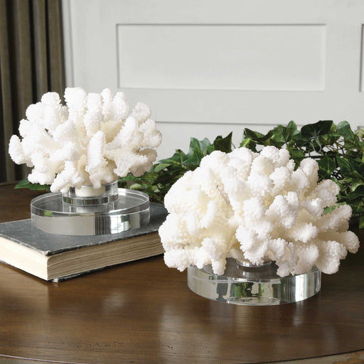 Pair of white hard coral sculptures by Uttermost, decorative figurines with intricate coral textures for coastal-inspired interior decor.
