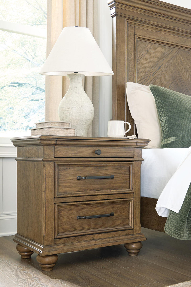 Medium brown Karallin three-drawer night stand from Signature Design by Ashley® with sleek accent style and wood grain finish.