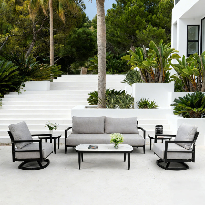 Life Outside 4-piece outdoor conversation set with chairs, bench sofa, tables, and Sunbrella cushions in a cozy patio scene.