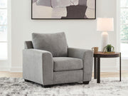 Benchcraft® arm chair with plush upholstery and wooden legs, showcasing a modern design and comfortable seating.