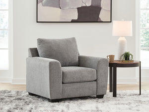 Benchcraft® arm chair with plush upholstery and wooden legs, showcasing a modern design and comfortable seating.