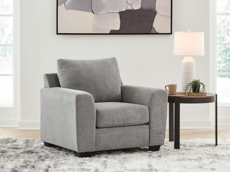 Benchcraft® arm chair with plush upholstery and wooden legs, showcasing a modern design and comfortable seating.