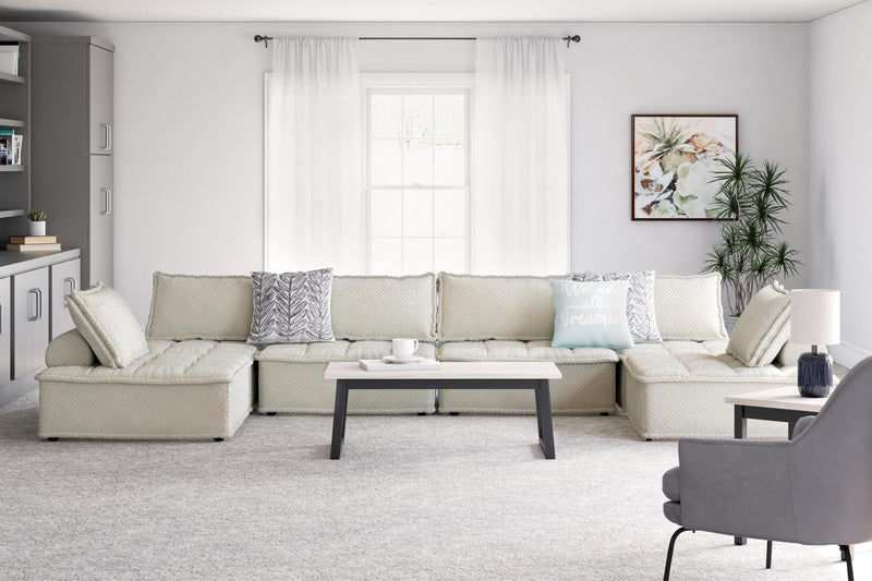Signature Design by Ashley stationary sectional sofa with plush cushions and neutral fabric, perfect for modern living rooms.
