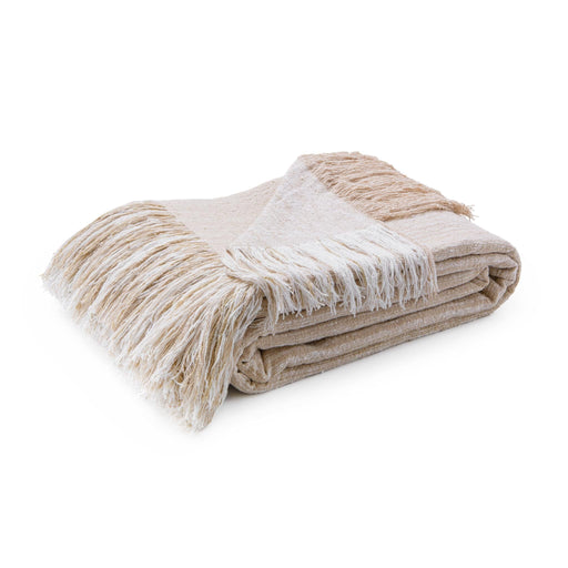 Soft beige Beryl blanket by Classic Home draped over a cozy armchair, showcasing its plush, textured fabric for warmth and comfort.