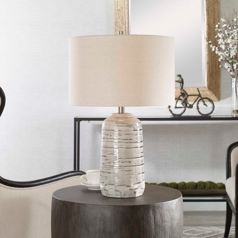 Uttermost Cyclone ivory table lamp with a textured base and fabric shade, ideal for classic or modern home decor.