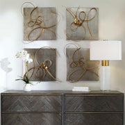 Set of two gold metal wall art pieces by Uttermost, modern wall decor with intricate geometric designs for stylish interior decor.