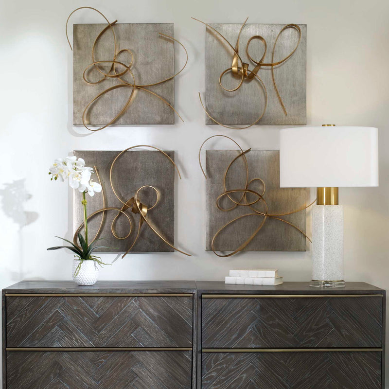 Set of two gold metal wall art pieces by Uttermost, modern wall decor with intricate geometric designs for stylish interior decor.