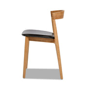 Raven - Stacking Sculpted Oak Dining Chair - Warm Natural Brown / Black - R&R Furniture Gallery (Fountain Valley, CA)