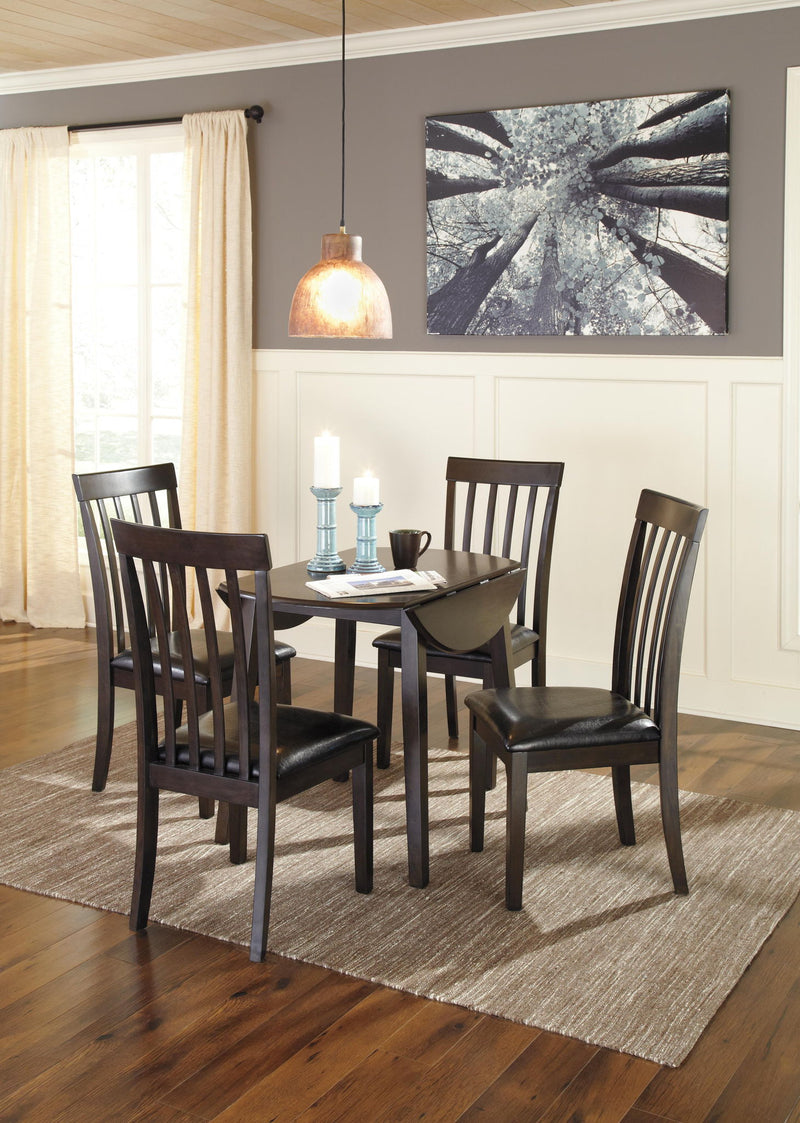 Dark brown round DRM Drop Leaf dining table by Signature Design by Ashley, featuring a smooth surface and sturdy drop leaves.