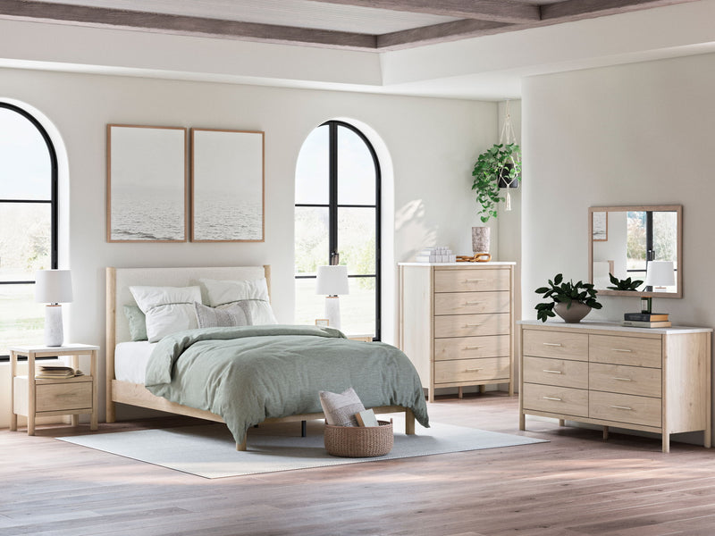 Signature Design by Ashley Cadmori 8-piece panel bedroom set with bed frame, dresser, mirror, and nightstands in a modern bedroom setting.