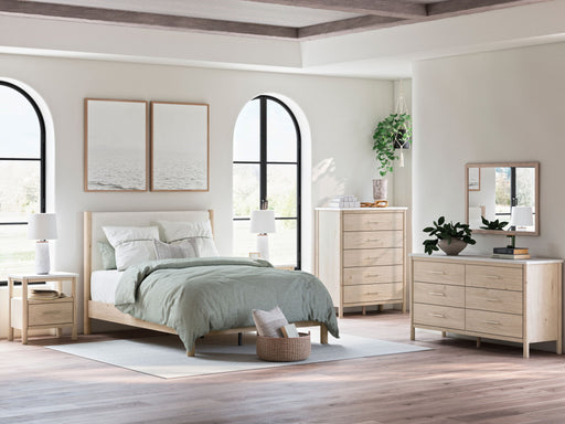 Signature Design by Ashley Cadmori 8-piece panel bedroom set with bed frame, dresser, mirror, and nightstands in a modern bedroom setting.
