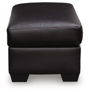 Midnight upholstered ottoman from Signature Design by Ashley, featuring a plush, padded surface and modern design.
