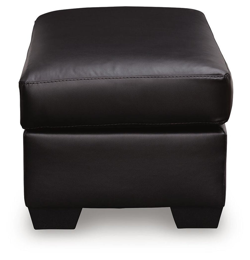 Midnight upholstered ottoman from Signature Design by Ashley, featuring a plush, padded surface and modern design.