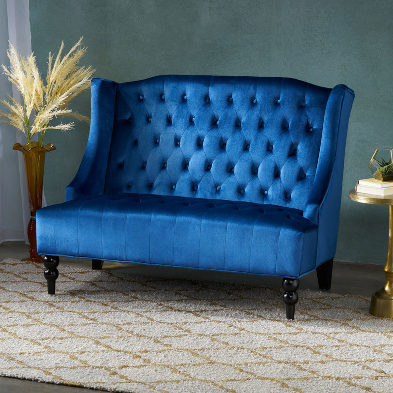 Noble House upholstered loveseat with wing back design and diamond tufting, featuring plush cushions and elegant fabric.