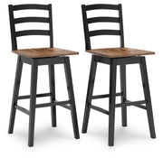 Set of two Signature Design by Ashley Wildenauer swivel stools with wooden seats and metal frames, ideal for kitchen or bar areas.