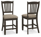 Set of two Signature Design by Ashley Tyler Creek upholstered barstools with black and grayish brown fabric, featuring padded seats and backrests.