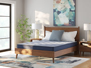Sierra Sleep® by Ashley Peak 2.0 Bonnell hybrid mattress with quilted top and supportive coils, shown in a bedroom setting.