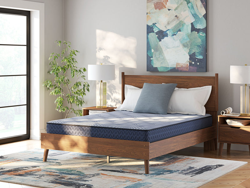 Sierra Sleep® by Ashley Peak 2.0 Bonnell hybrid mattress with quilted top and supportive coils, shown in a bedroom setting.