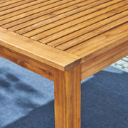 Outdoor expandable dining table by Noble House with square legs, featuring a spacious surface and extendable design for outdoor dining.