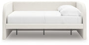 Signature Design by Ashley Arloster upholstered day bed with plush cushioning and wooden frame, perfect for lounging and guest sleeping.