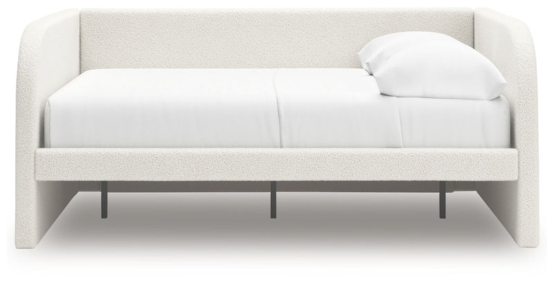 Signature Design by Ashley Arloster upholstered day bed with plush cushioning and wooden frame, perfect for lounging and guest sleeping.