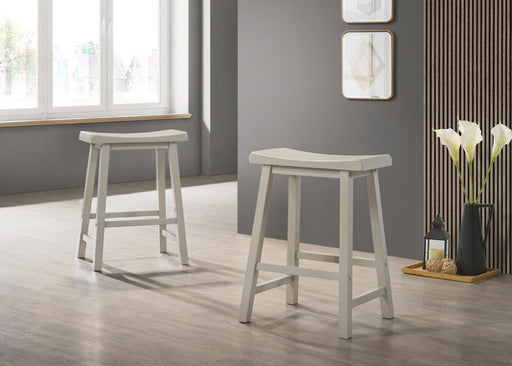 Set of two Lilola Home Alonzo 17.5-inch backless ergonomic counter height stools with wooden legs and neutral fabric seats.