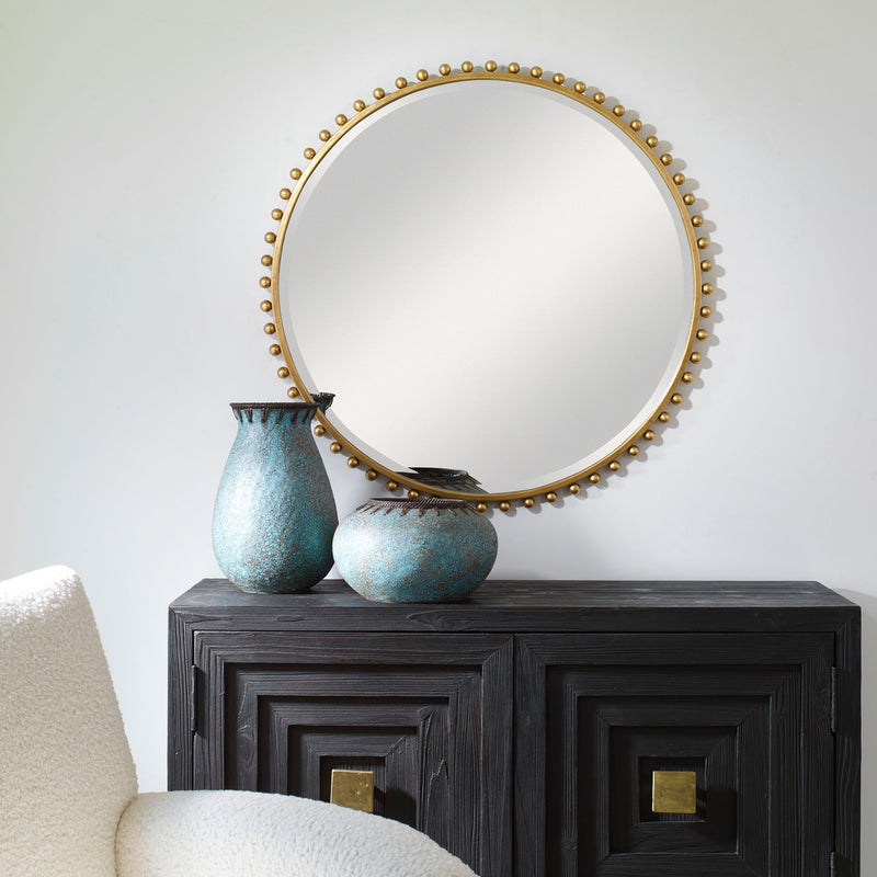 Round iron wall mirror by Uttermost featuring a sleek, minimalist design suitable for modern interiors.