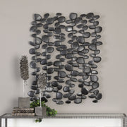 Black forged iron wall art featuring stacked skipping stones design by Uttermost, ideal for modern wall decor.