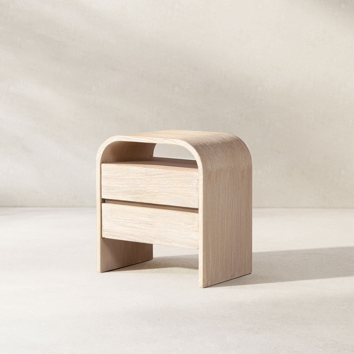 White washed Dune side table by Jennifer Taylor Home with a sleek, modern design and smooth finish.