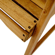 Set of two Noble House outdoor weather-resistant acacia wood Adirondack dining chairs on a patio.