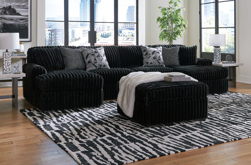 Signature Design by Ashley Midnight-Madness 4-piece sectional set for living room with plush cushions and modern design.