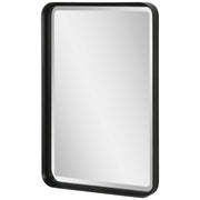 Uttermost Croften black vanity mirror with a sleek rectangular frame, reflecting a modern bathroom or dressing area.