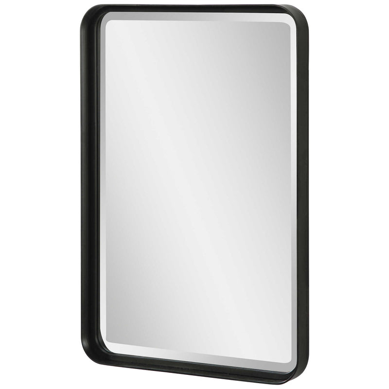 Uttermost Croften black vanity mirror with a sleek rectangular frame, reflecting a modern bathroom or dressing area.
