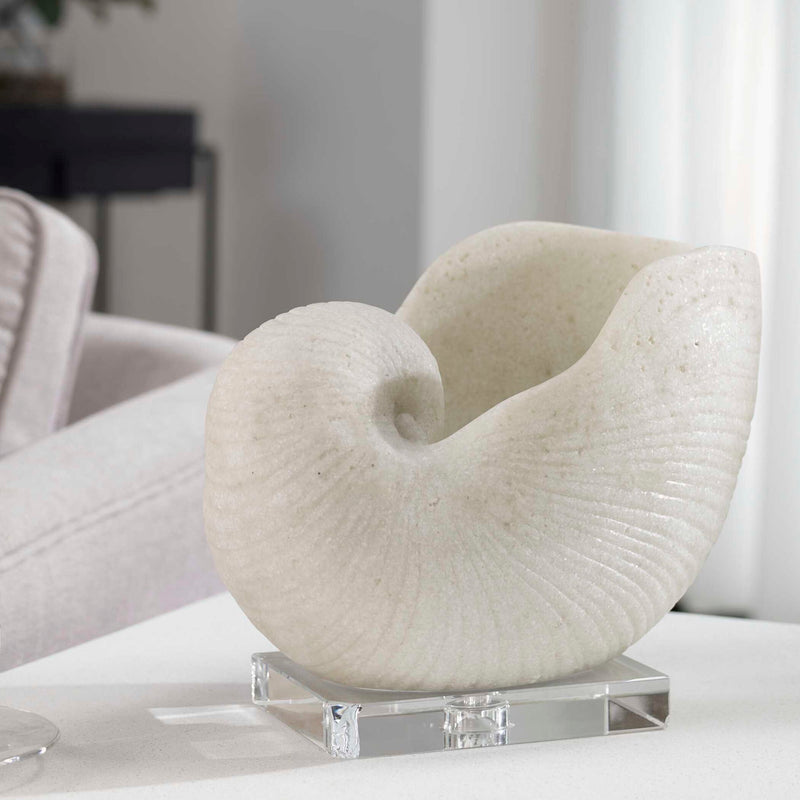 White Nautilus shell sculpture by Uttermost, detailed ceramic figurine representing ocean-inspired decor.